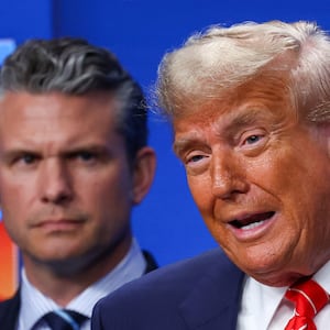 U.S. President Donald Trump speaks next to U.S. Defense Secretary Pete Hegseth, during a press conference at a NATO summit in The Hague, Netherlands June 25, 2025. REUTERS/Yves Herman