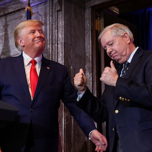FILE PHOTO: U.S. Senator Lindsey Graham (R-SC) gestures, while standing next to former U.S. President Donald Trump, during Donald Trump's campaign stop to unveil his leadership team, at the South Carolina State House in Columbia, South Carolina, U.S., January 28, 2023. REUTERS/Shannon Stapleton/File Photo