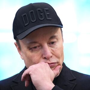 Tesla CEO Elon Musk listens as U.S. President Donald Trump speaks to reporters in the Oval Office of the White House on May 30, 2025, in Washington, D.C.