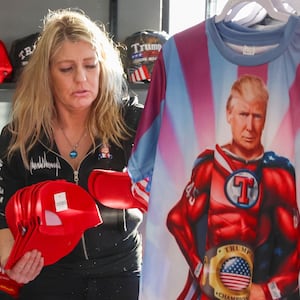 Lisa Fleischmann dozens of hats in her soon-to-open store, the Trump Truth Store and Hangout, on Jan. 13, 2026, in Crystal Lake. The store features pro-Trump t-shirts, hats, glass ware, flags, and many other items. (Stacey Wescott/Chicago Tribune/Tribune News Service via Getty Images)