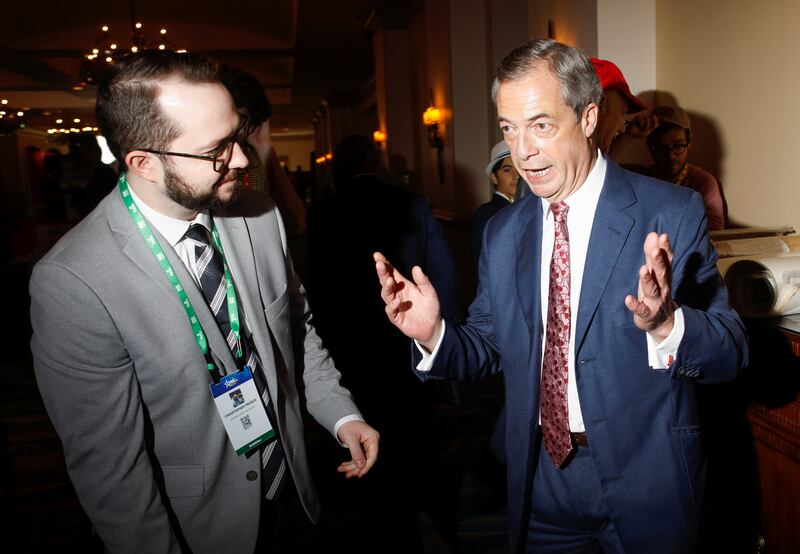 Former British Parliament member Nigel Farage talks to Christopher Prosch of Enemies within the Church at the Conservative Political Action Conference (CPAC) in Orlando, Florida, U.S. February 24, 2022. REUTERS/Octavio Jones