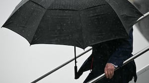 President Donald Trump steps off Air Force One under an umbrella upon arrival at Atlantic Aviation at Cleveland Hopkins International Airport in Cleveland, Ohio, on August 11, 2026. Trump is attending the Patriot Games at SPIRE Academy in Geneva, Ohio.