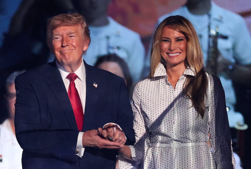 U.S. President Donald Trump and first lady Melania Trump hold hands as they attend a Fourth of July rally, marking the 250th anniversary of U.S. independence, on the National Mall in Washington, D.C., U.S., July 4, 2026.