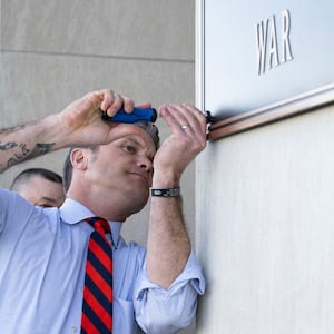 Secretary of War Pete Hegseth finishes the installation of a Department of War plaque at the River Entrance in front of the Pentagon, Washington, D.C., Nov. 13, 2025.