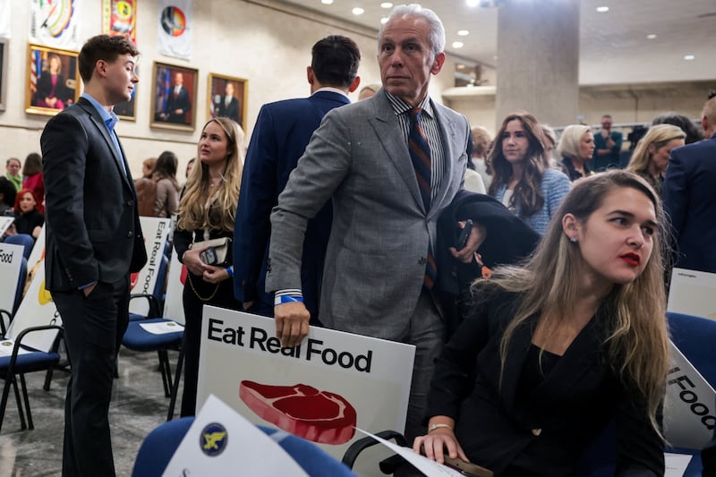 Geoffrey Zakarian, a chef and television personality, holds an ”Eat Real Food” placard ahead of an announcement from RFK Jr.