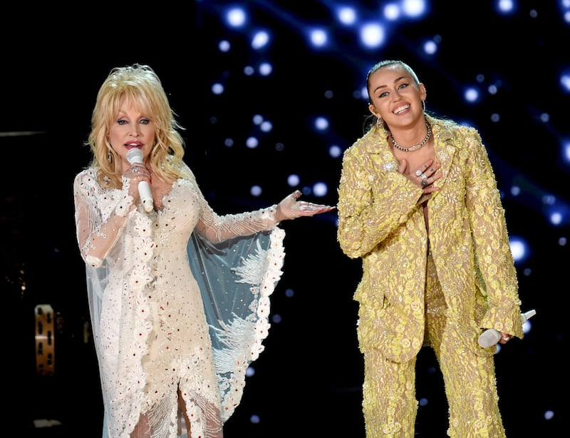 Dolly Parton (L) and Miley Cyrus perform onstage during the 61st Annual GRAMMY Awards in 2019.
