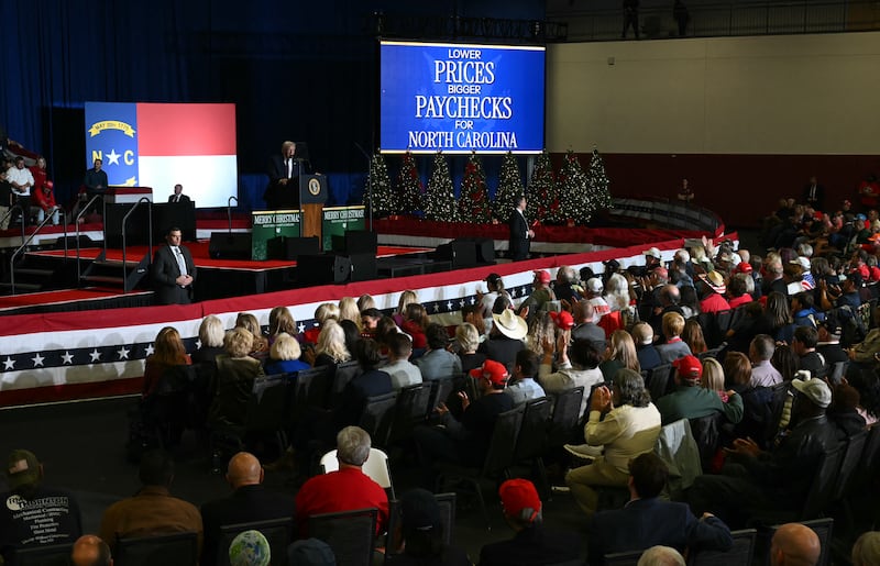 Attendees listen to US President Donald Trump speak during a political rally in Rocky Mount, North Carolina on December 19, 2025. (Photo by ANDREW CABALLERO-REYNOLDS / AFP via Getty Images)