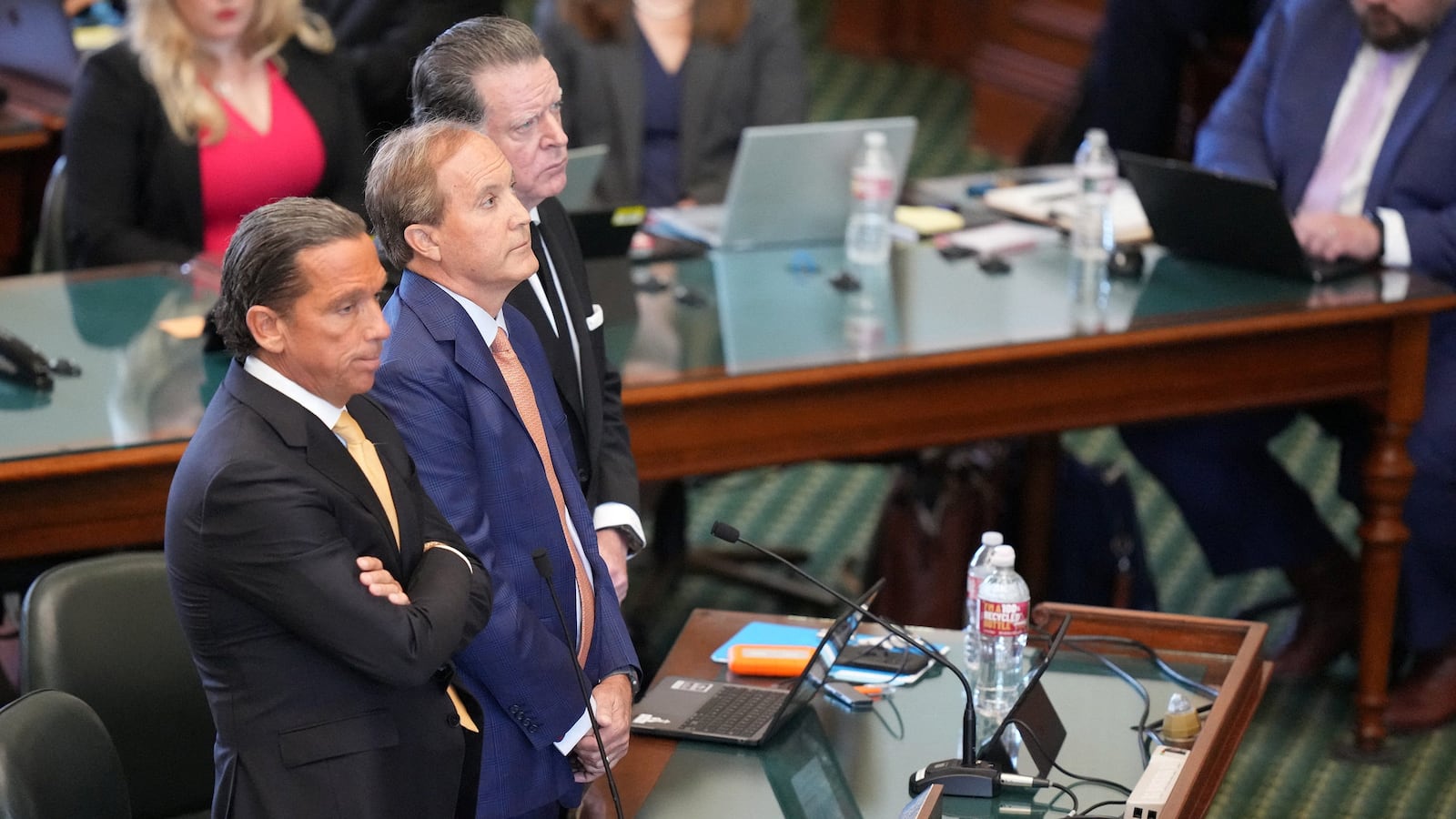 Ken Paxton stands between his attorneys during an impeachment hearing.