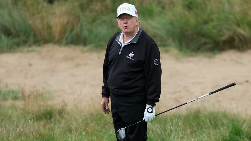 President Donald Trump holds a driver after teeing off during the opening of his new golf course at his Trump International Golf links resort on July 29, 2025 in Balmedie, Scotland.