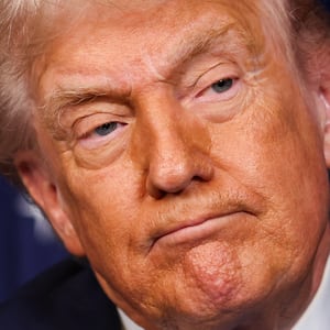 U.S. President Donald Trump listens during a press conference with Ukrainian President Volodymyr Zelensky following their meeting at Trump’s Mar-a-Lago club on December 28, 2025 in Palm Beach, Florida. Trump invited Zelensky to his private club to work on the U.S.-proposed peace plan to end the war in Ukraine, as the conflict approaches four years since the sudden full-scale invasion by Russia on February 24, 2022. (Photo by Joe Raedle/Getty Images)