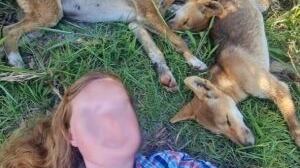 A photo of one of the two Australian women fined for taking selfies with dingoes, who is seen lying next to three sleeping pups.