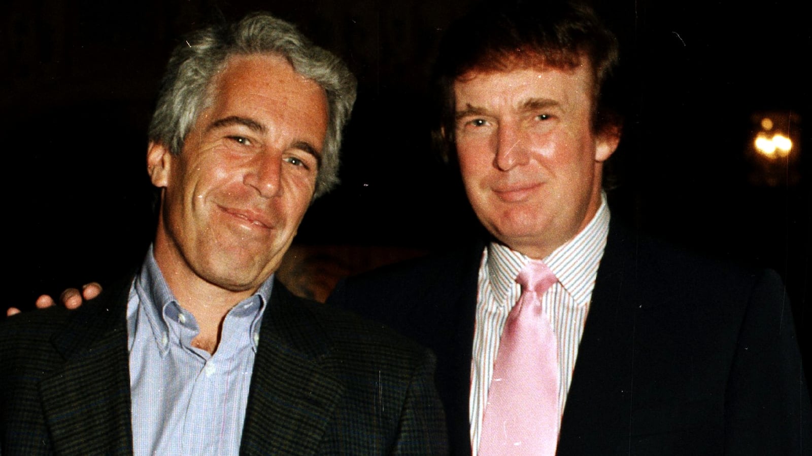 Jeffrey Epstein (left) and Donald Trump pose together at the Mar-a-Lago estate, Palm Beach, Florida on February 22, 1997.