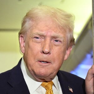 US President Donald Trump speaks with reporters aboard Air Force One