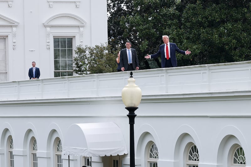 President Donald Trump gestures while answering questions from reporters as he tours the roof of the West Wing of the White House on August 05, 2025 in Washington, DC.