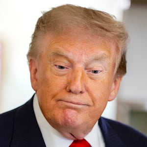 U.S. President Donald Trump reacts as he speaks to reporters aboard Air Force One en route to Michigan, U.S., July 27, 2026.