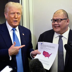 US President Donald Trump speaks with journalist, alongside White House Communications Director Steven Cheung (R), on board Air Force One on route from Miami, Florida, to the White House in Washington, DC on February 19, 2025. (Photo by ROBERTO SCHMIDT / AFP) (Photo by ROBERTO SCHMIDT/AFP via Getty Images)