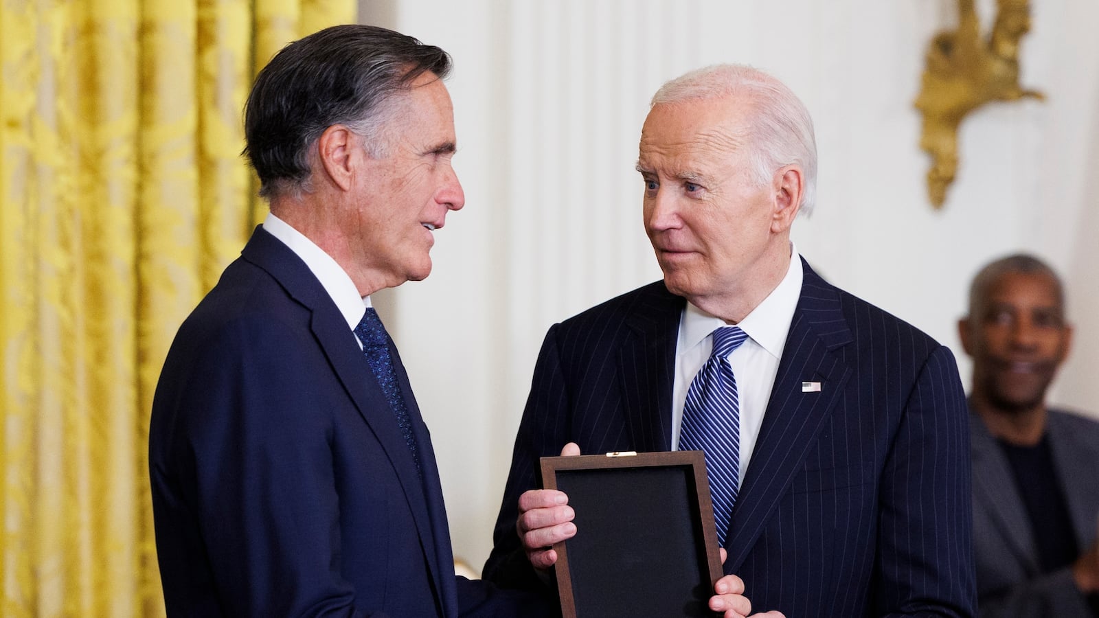 Sen. Mitt Romney receives the the Presidential Medal of Freedom on behalf of his father, former Michigan Gov. George Romney, from U.S. President Joe Biden in the East Room of the White House on January 4, 2025 in Washington, DC.