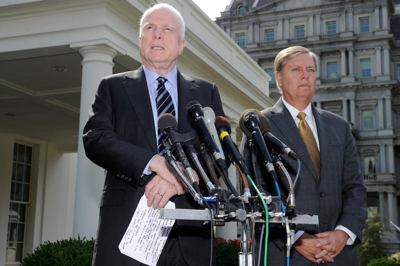 U.S. Senator John McCain (R-AZ), (L), makes remarks to the media as U.S. Senator Lindsey Graham (R-SC) listens, after meeting with U.S. President Barack Obama at the White House, on possible military action against Syria, in Washington September 2, 2013. REUTERS/Mike Theiler (UNITED STATES - Tags: CIVIL UNREST POLITICS)