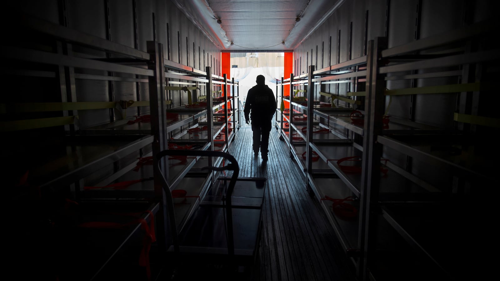 A Los Angeles County Department of Medical Examiner-Coroner (DMEC) staff member inspects a refrigerated container in Los Angeles, California, Jan. 27, 2021.