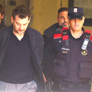 Jonathan Andic, the son of the founder of the Mango fashion group, Isak Andic, arrives at court escorted by police.