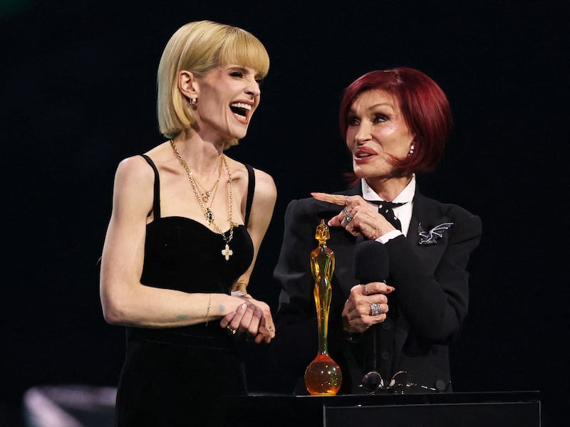 Kelly Osbourne and Sharon Osbourne accept the Lifetime Achievement Award for Ozzy Osbourne during the 2026 BRIT Awards.