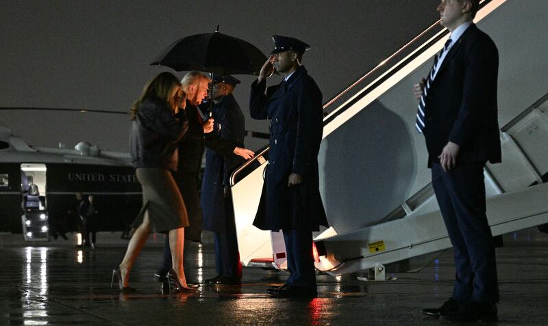 President Donald Trump and First Lady Melania Trump board Air Force One at Joint Base Andrews on November 25, 2025.