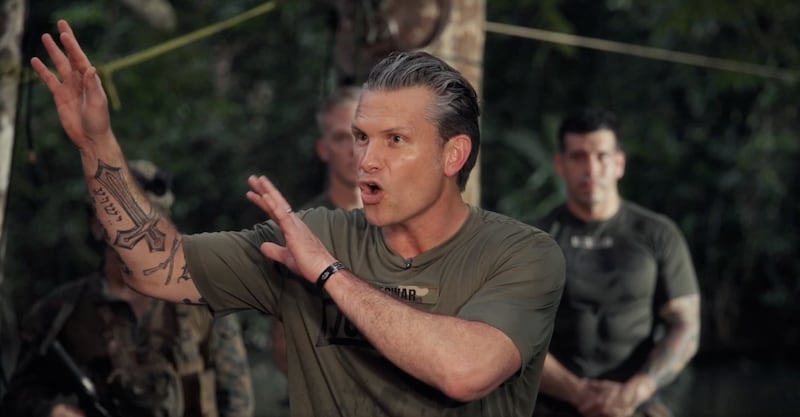 A sliver of Hegseth's "Deus Vult" tattoo is visible on his right bicep. The phrase, used by Christians in the crusades, has since become linked to white extremist groups.