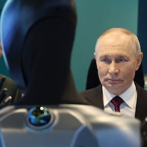 In this pool photograph distributed by the Russian state agency Sputnik, Russia's President Vladimir Putin, accompanied by Sberbank's CEO German Gref, visits an exhibition of the AI Journey international AI (Artificial intelligence) conference in Moscow on November 19, 2025. Russia's anthropomorphic AI-equipped robot developed by technology company Sber was presented to the Russian leader. (Photo by Vyacheslav PROKOFYEV / POOL / AFP) (Photo by VYACHESLAV PROKOFYEV/POOL/AFP via Getty Images)