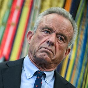 U.S. Secretary of Health and Human Services Robert F. Kennedy Jr. (R) looks on as President Donald Trump speaks before signing an executive order calling for more research and flexibility on vaccines.