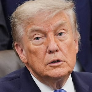 U.S. President Donald Trump receives the report from his Religious Liberty Commission in the Oval Office of the White House in Washington, D.C., U.S., June 26, 2026. REUTERS/Ken Cedeno