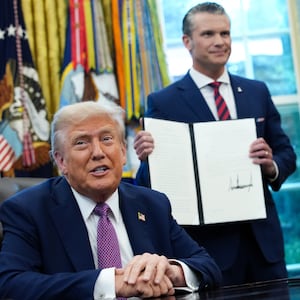 President Donald Trump speaks to the media after signing an executive order renaming the Department of Defense to the Department of War as U.S. Defense Secretary Pete Hegseth and Chairman of the Joint Chiefs of Staff Air Force Gen. Dan Caine look on.