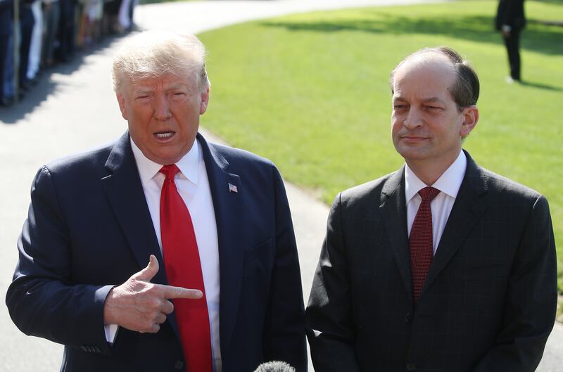 President Donald Trump stands with Labor Secretary Alex Acosta.