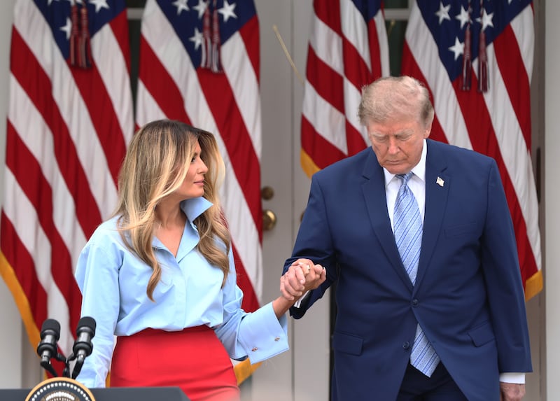 President Donald Trump and first lady Melania Trump arrive during an event announcing the expansion of a foster care initiative in the Rose Garden of the White House on August 20, 2026 in Washington, DC.