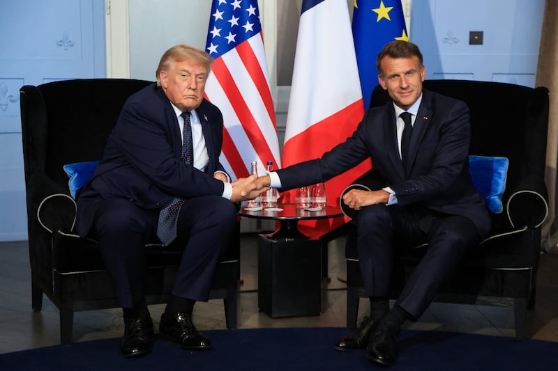 US President Donald Trump (L) shakes hands with France's President Emmanuel Macron during a bilateral meeting on the sidelines of the G7 summit, in Evian, France on June 15, 2026.  LUDOVIC MARIN/Pool via REUTERS