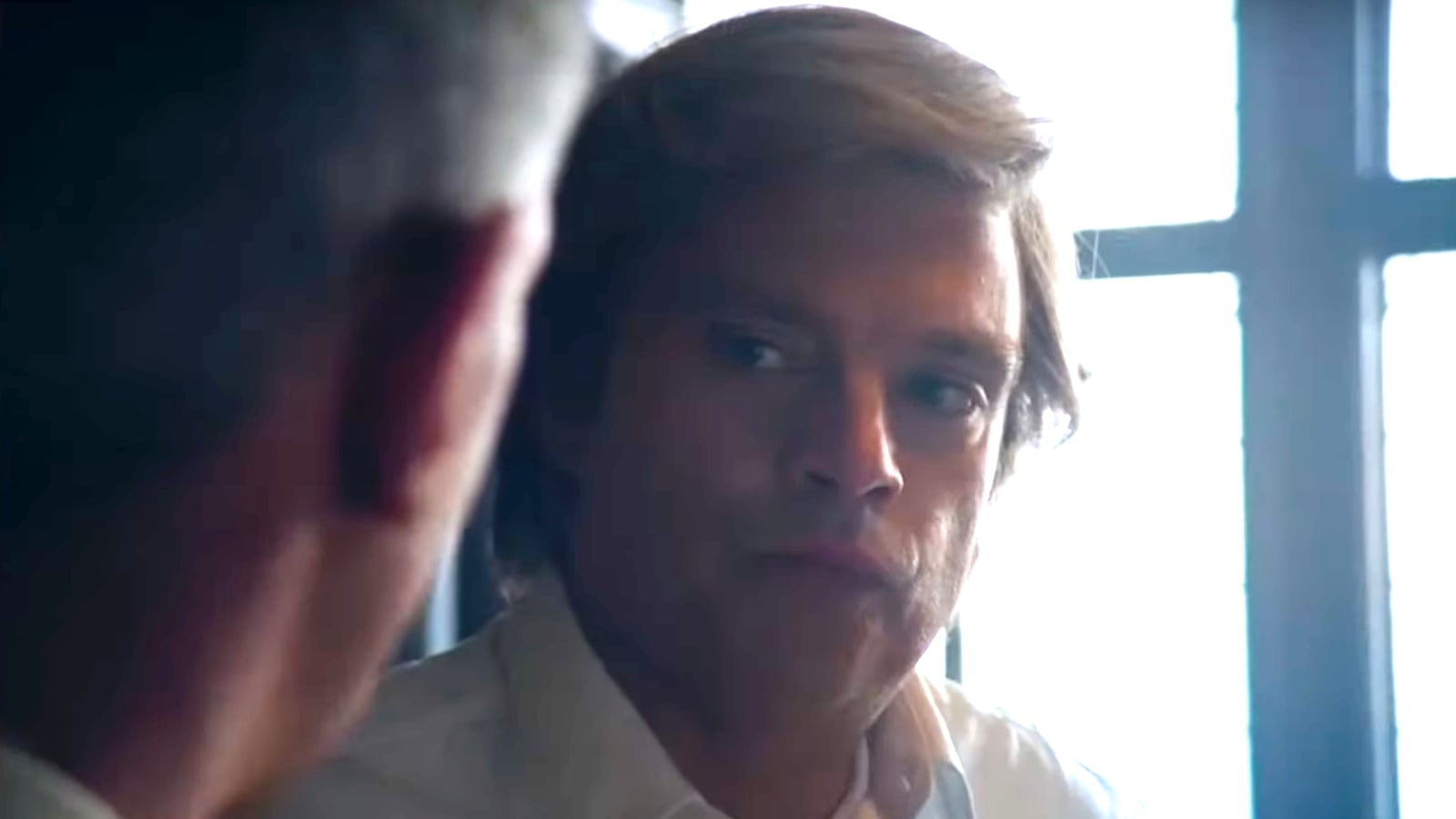 Donald Trump’s character in “The Apprentice” stares forward.