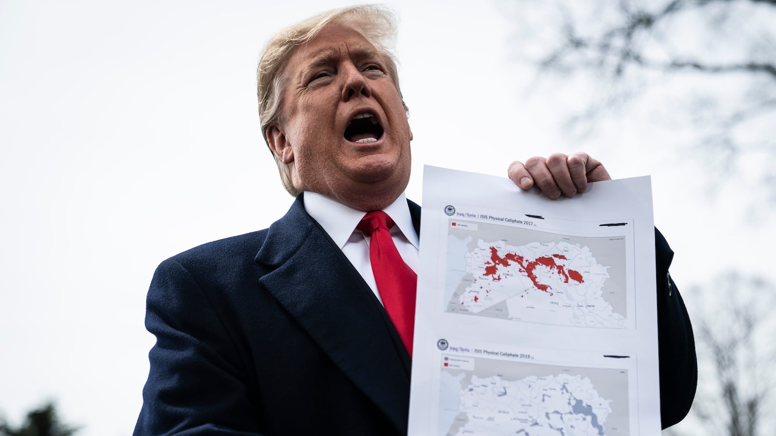 WASHINGTON, DC - MARCH 20 : President Donald J. Trump stops to speak to reporters and members of the media and to show a map of ISIS controlled territory as he walks to Marine One to depart from the South Lawn at the White House on Wednesday, March 20, 2019 in Washington, DC. (Photo by Jabin Botsford/The Washington Post via Getty Images)