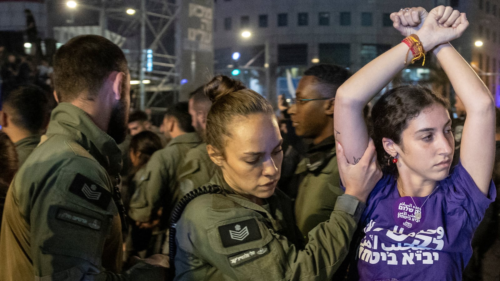 A demonstrator is detained by a member of security forces during a protest against Israeli Prime Minister Benjamin Netanyahu's government and to call for the release of hostages kidnapped in the deadly October 7 attack in Tel Aviv, Israel, June 1, 2024.