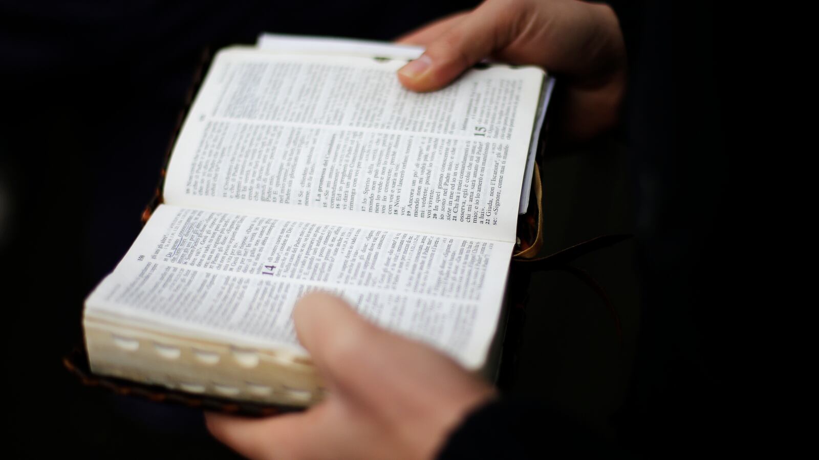 A man holding an open bible
