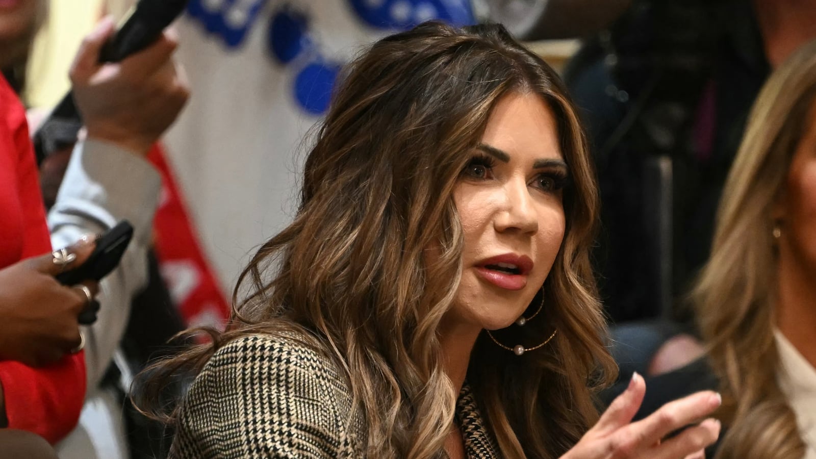 US Secretary of Homeland Security Kristi Noem (C) speaks, during a Cabinet Meeting in the Cabinet Room of the White House in Washington, DC on December 2, 2025.