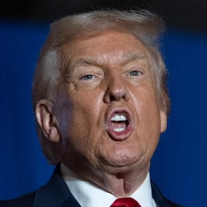 US President Donald Trump sings upon his arrival to deliver remarks on the economy at Mount Airy Casino Resort in Mount Pocono, Pennsylvania, on December 9, 2025. (Photo by ANDREW CABALLERO-REYNOLDS / AFP via Getty Images)