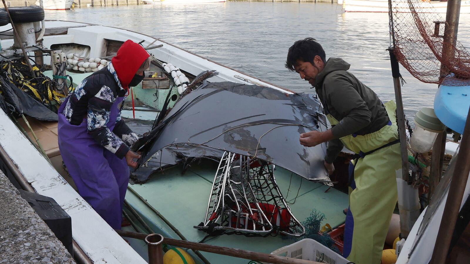 Recovered debris, believed to be part of wreckage from a crashed US Air Force CV-22B Osprey tilt-rotor aircraft, is brought ashore at a port in Yakushima-cho, Kagoshima.