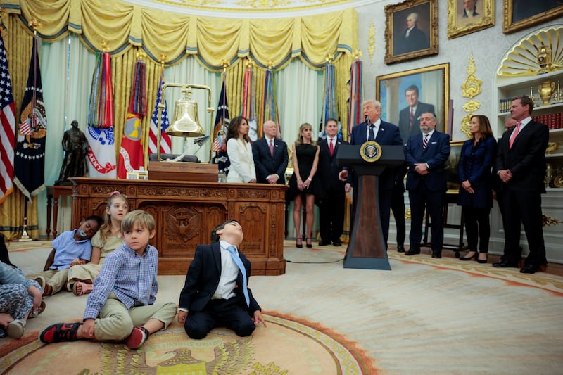 Children rest on the floor as U.S. President Donald Trump speaks during an event to mark the launch of "Trump Accounts" in the Oval Office at the White House in Washington, D.C., U.S., July 6, 2026. REUTERS/Evan Vucci