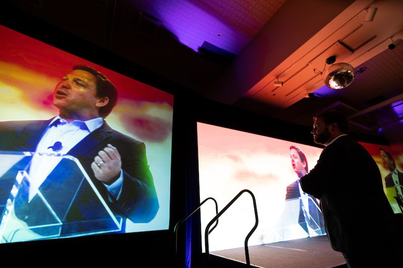 Republican U.S. Senate candidate J.D. Vance watches the intro video for Gov. Ron DeSantis at their Turning Point Action rally in Youngstown, Ohio on Friday, August 19, 2022.