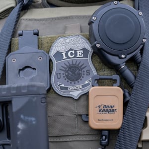 Close-up of an ice officer's badge and gear.