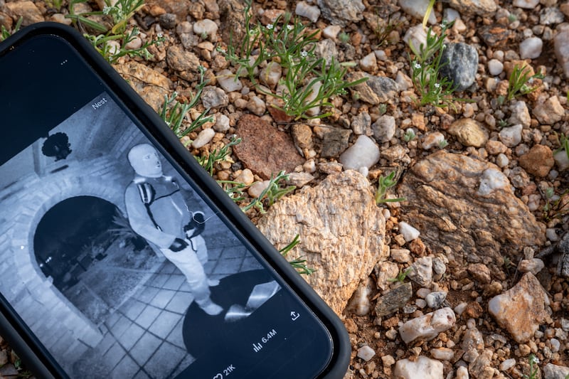 In this photo illustration, Nancy Guthrie's alleged kidnapper is seen on FBI Director Kash Patel's X account on a cellular phone