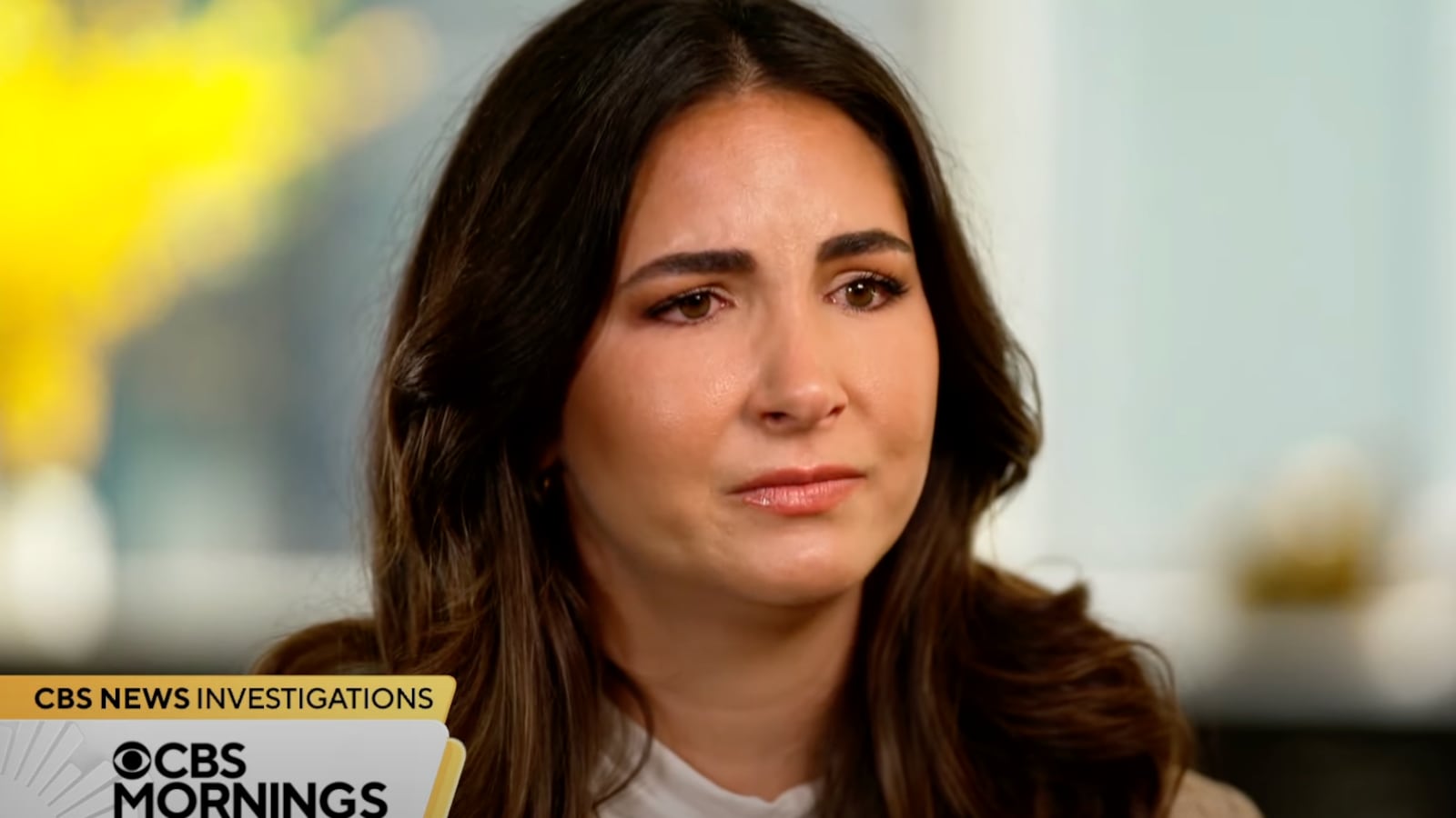 Trashelle Odom fights back tears in a TV interview.