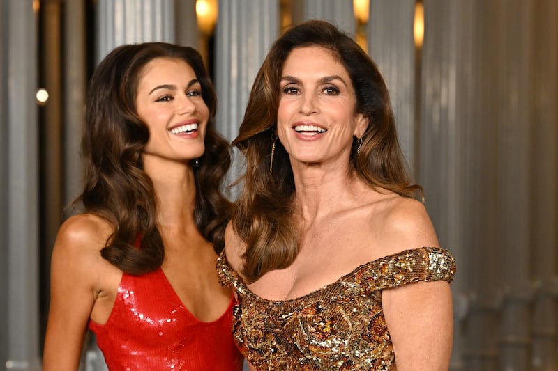 Kaia Gerber and Cindy Crawford pose, smiling and giggling, at the 2025 LACMA Art + Film Gala.