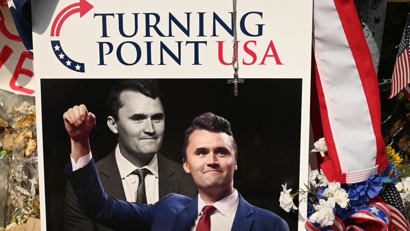 A pile of flowers, candles, and photos placed outside the original Turning Point USA office in Lemont, founded by Charlie Kirk, on Sunday, September 21, 2025.