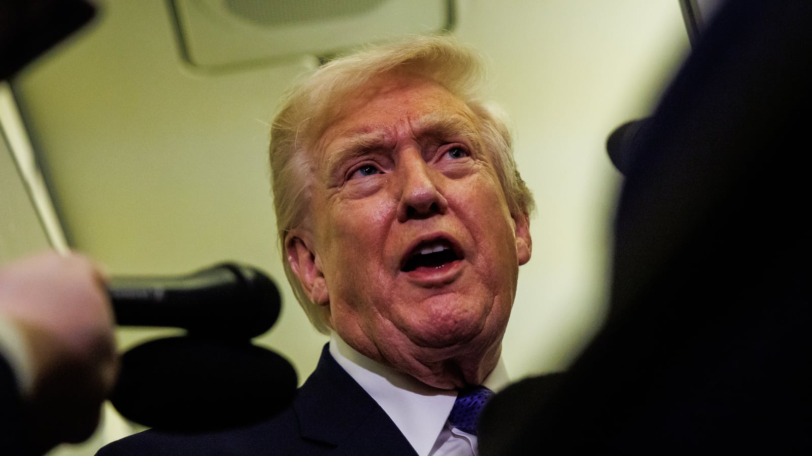 President Donald Trump gaggles with reporters while aboard Air Force One on February 6, 2026 en route to Palm Beach, Florida.