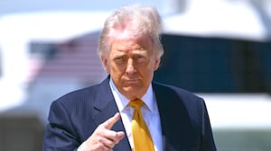 US President Donald Trump gestures prior boarding Air Force One at Joint Base Andrews, Maryland, on May 12, 2026.